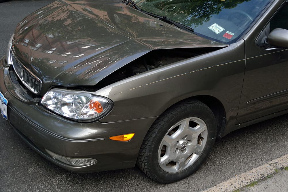 Gray car with bent hood