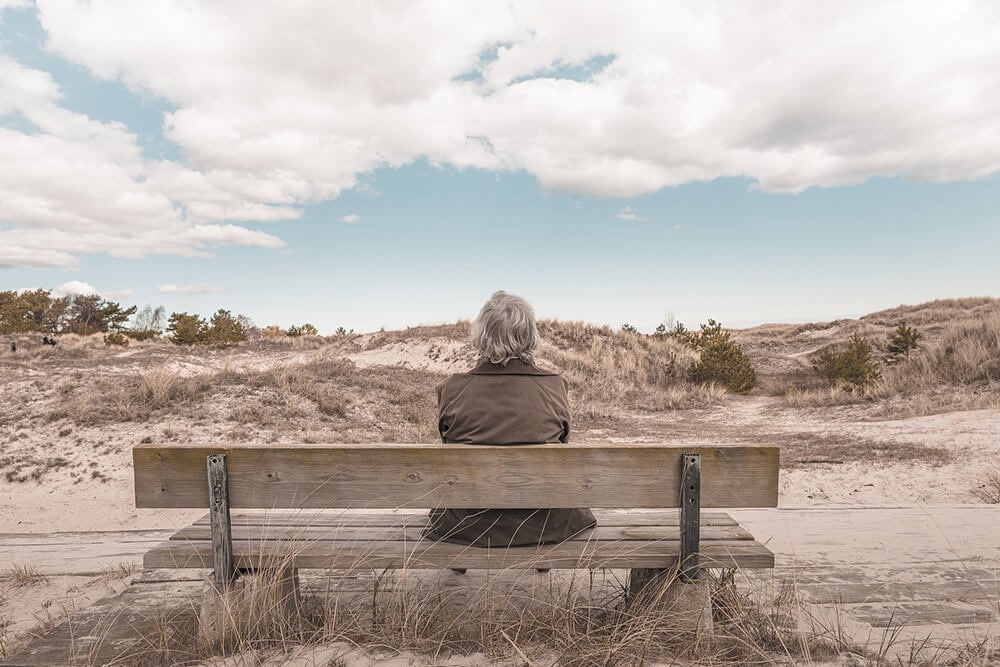 Elderly woman sitting on bench