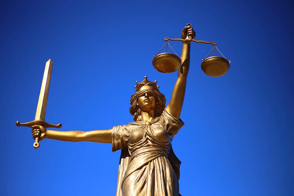 Statue of justice holding scales and a sword