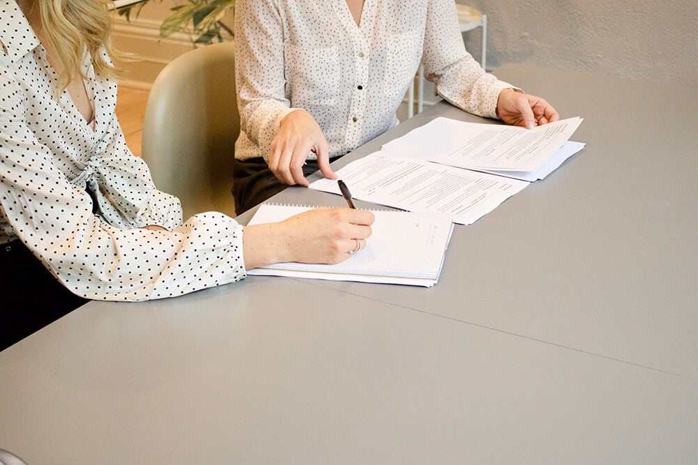 Two women going over forms