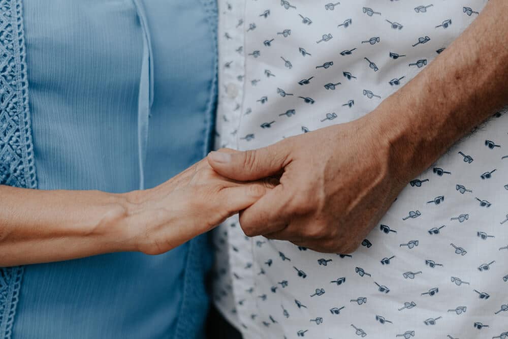 Nurse and patient holding hands