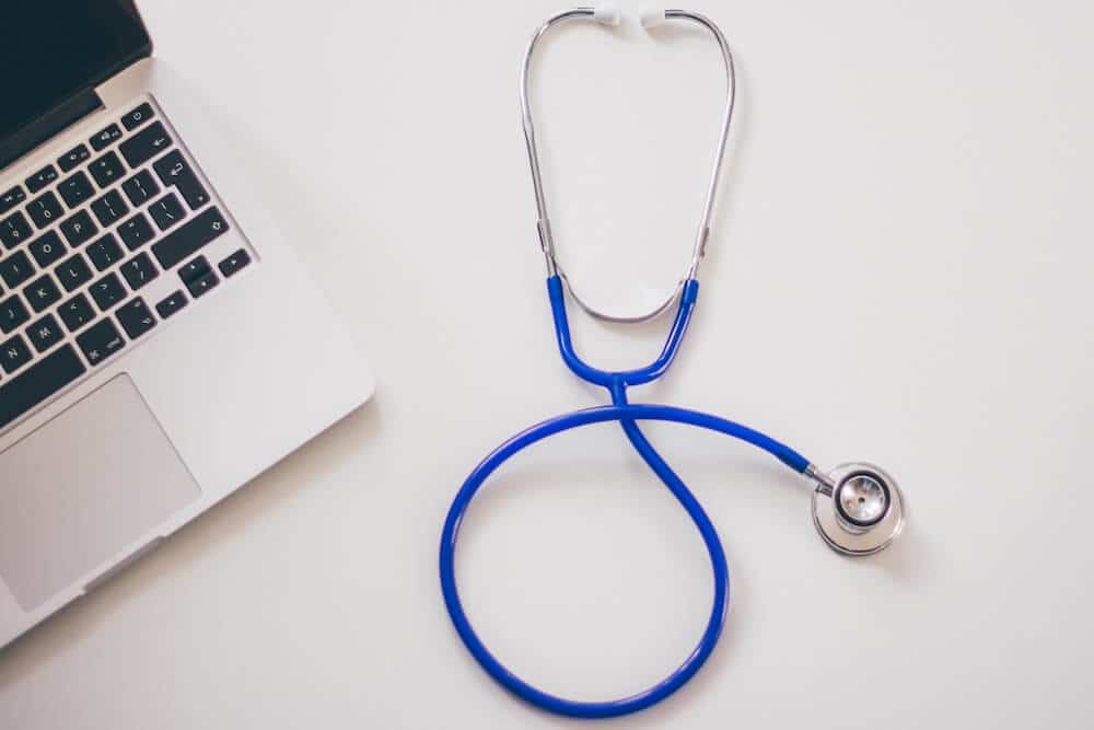 Stethoscope next to laptop